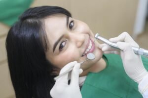 a young woman having teeth examined by dentist in dental clinic teeth check up and healthy teeth concept free photo